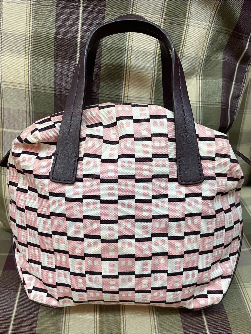 Bally mini with a monogrammed checkerboard pattern and brown leather handles.